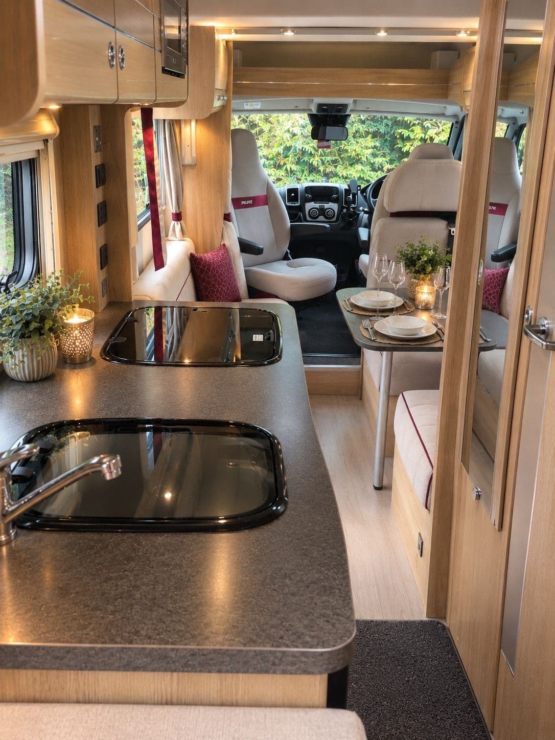 The kitchen worktop with sink and gas hob, looking through to the dining area and cab